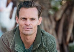 Close-up portrait of a man wearing a casual jacket outdoors.